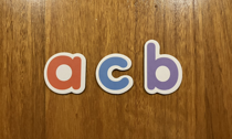 The letters 'a', 'c' and 'b'