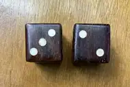Two dice. The first with the 3 side up, the second with the 2 side up